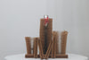 Set of brown textured vases on a white surface with a light gray background